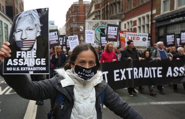 Protestors call for Mr Assange's release. / AP