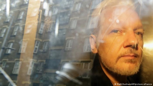 Julian Assange in a car travelling to court in 2019. AP
